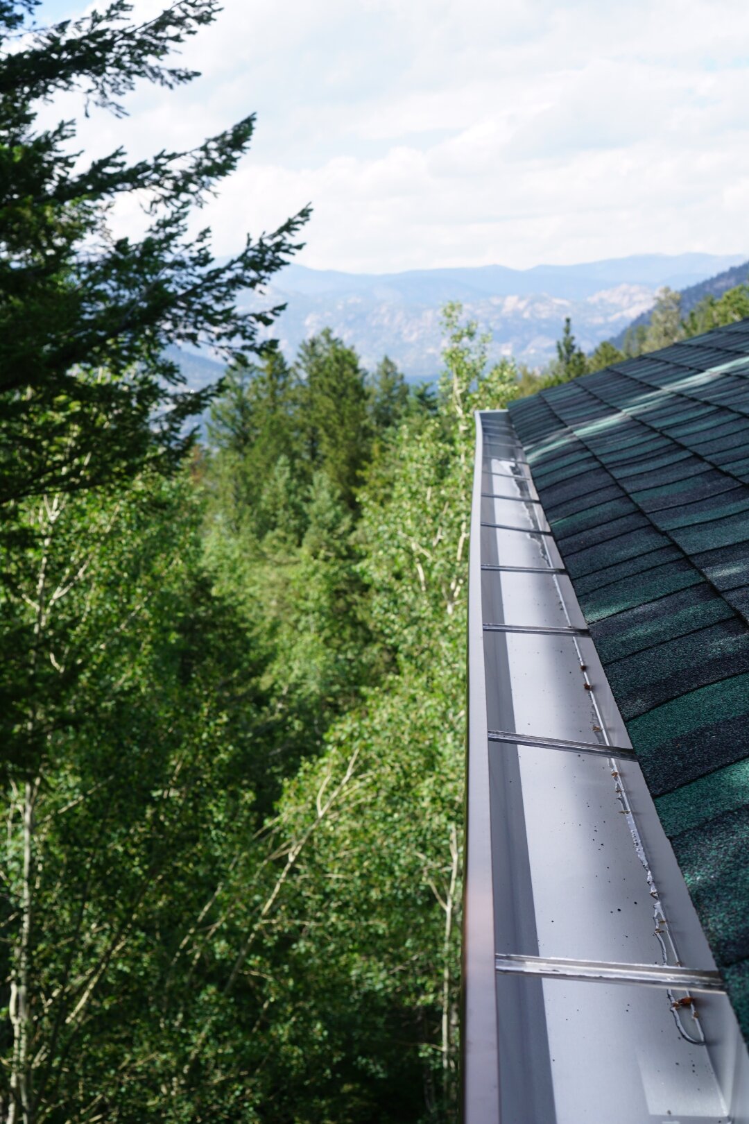 Newly installed seamless aluminum gutter overlooking the Colorado foothills.